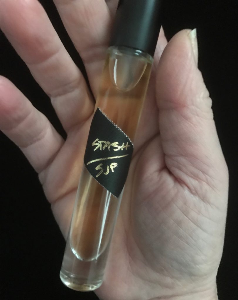 closeup of Stash SJP eau de parfum rollerball to show the amber color, neversaydiebeauty.com