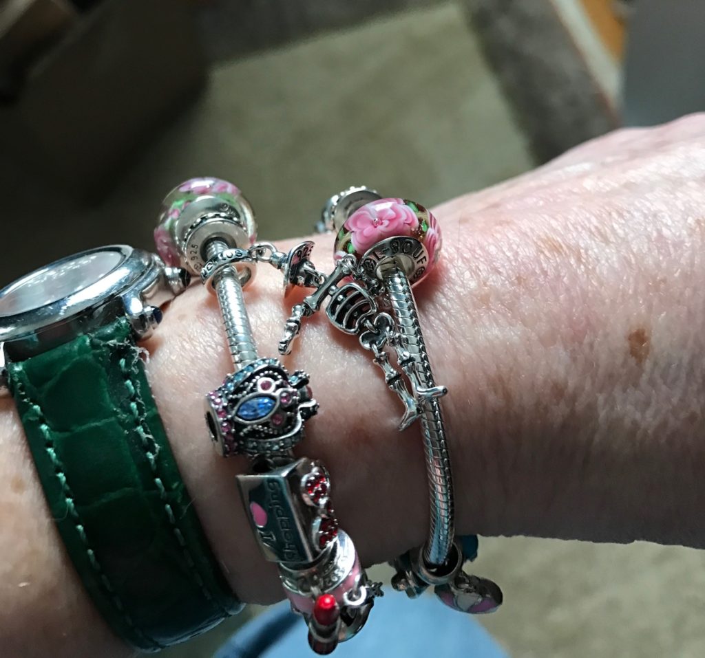 me wearing two Soufeel charm bracelets on my wrist with my watch, neversaydiebeauty.com