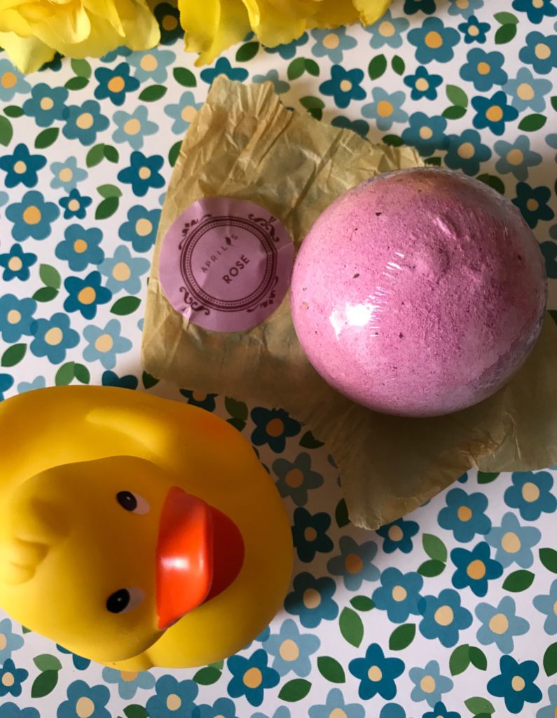 Aprilis rose bath bomb protectively wrapped in plastic, neversaydiebeauty.com