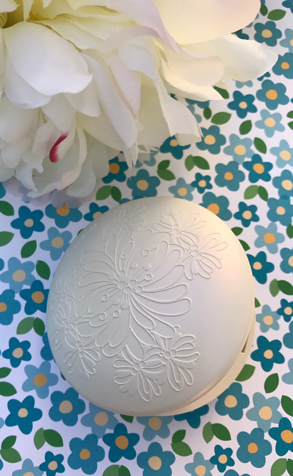 closeup of the Paul & Joe Gel Foundation white plastic compact, neversaydiebeauty.com