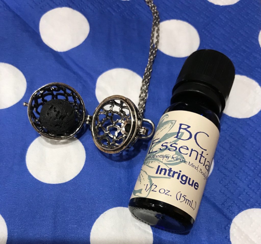 BC Essentials essential oil, Intrigue, along with a lava ball from an aromatherapy necklace, neversaydiebeauty.com