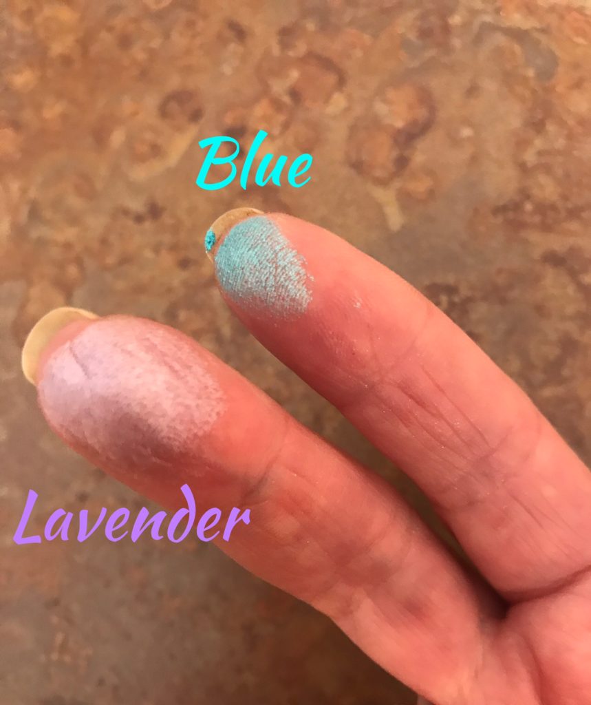 blue & lavender finger swatches of Wet N Wild Rainbow Highlighter, Unicorn Glow, neversaydiebeauty.com