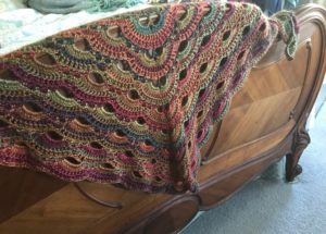 crocheted "virus" shawl in pinks/purple made with Red Heart's Unforgettable Petunia yarn,neversaydiebeauty.com