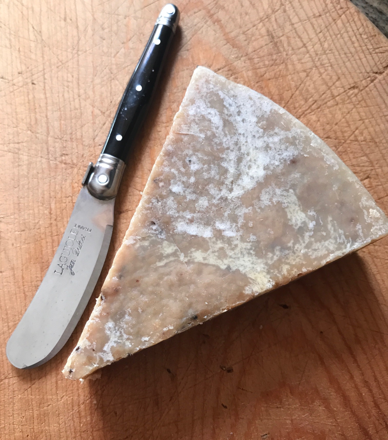 wedge-shaped unwrapped Farmhouse Fresh soap on a cutting board, neversaydiebeauty.com