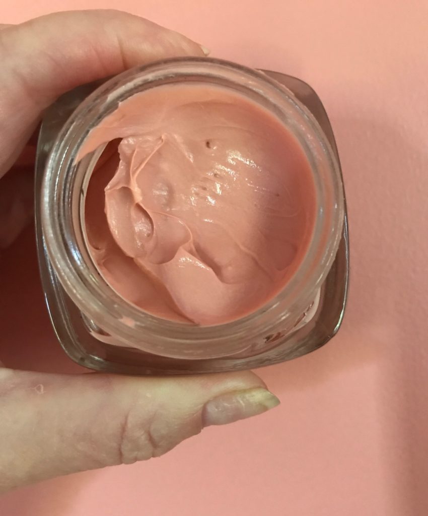 L'Oreal Age Perfect Rosy Tone Moisturizer peachy-pink cream in an open jar against my hallway walls that are the same shade, neversaydiebeauty.com