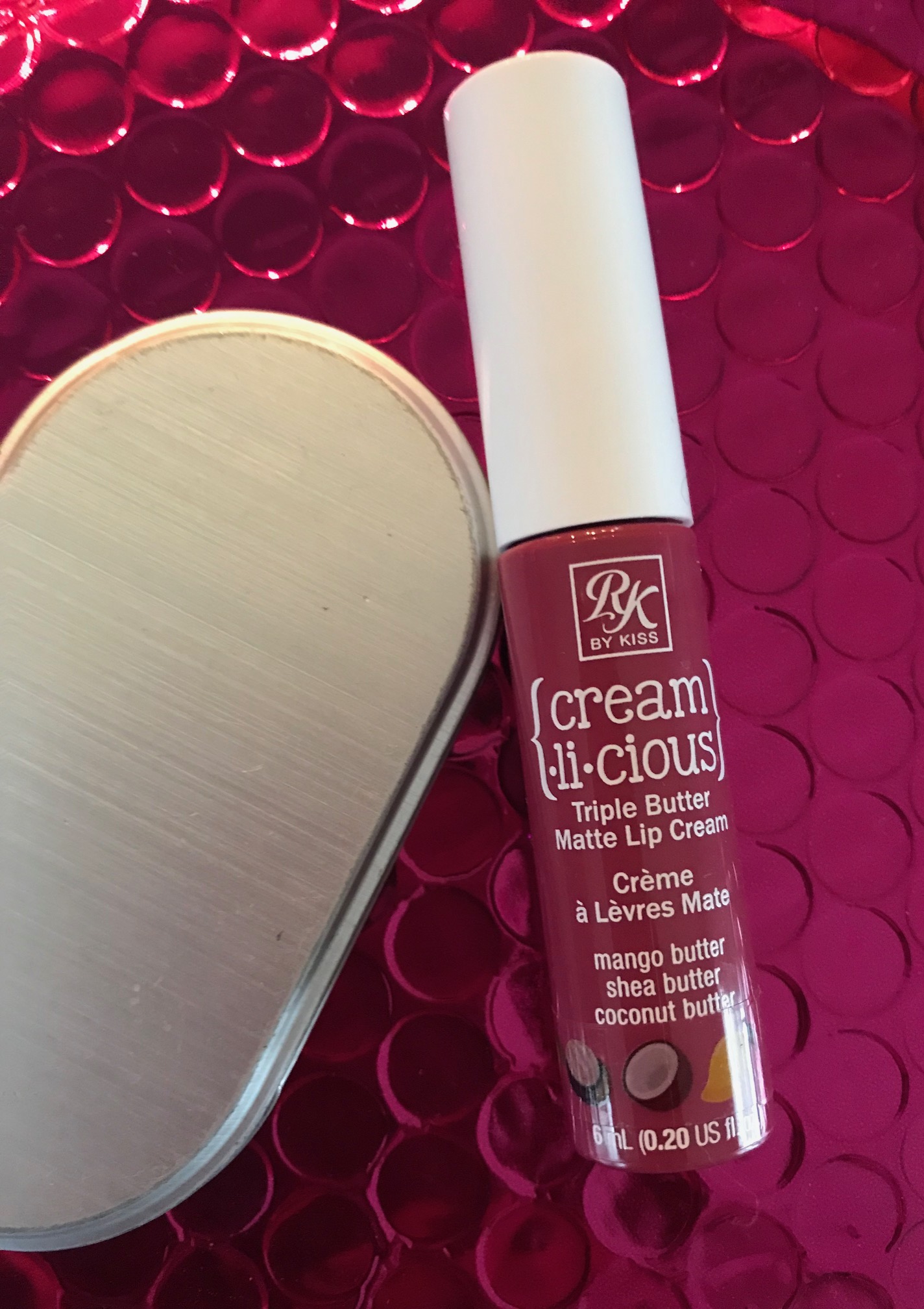 a tube of RK by KISS Cream.li.cious Triple Butter Matte Lip Cream in Berry In Love, neversaydiebeauty.com