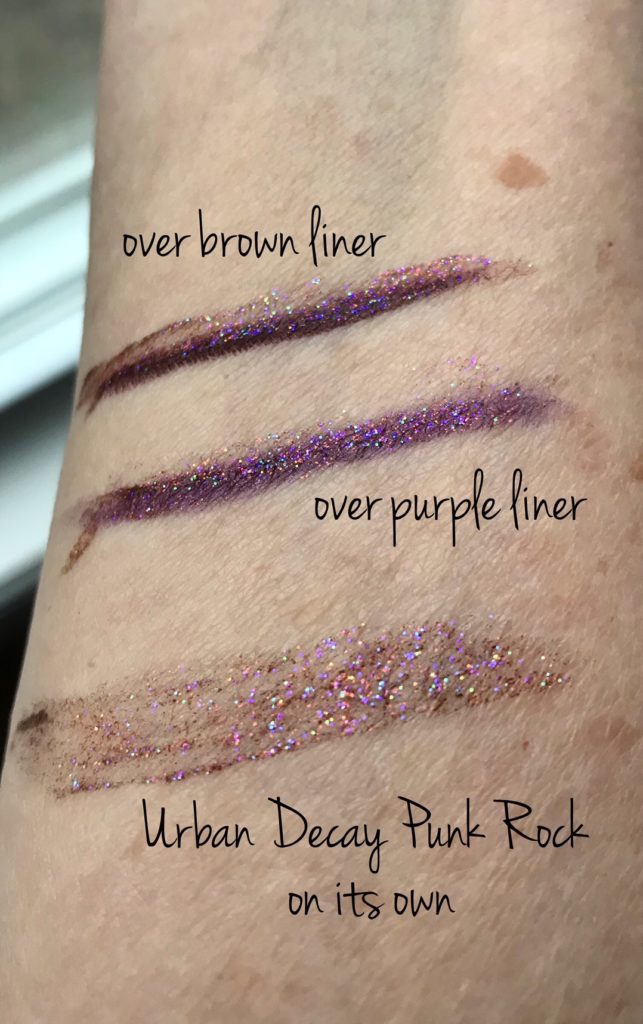 swatches of Urban Decay Heavy Metals Glitter Eyeliner in the shade Punk Rock over brown pencil liner, purple liner and on its own, neversaydiebeauty.com
