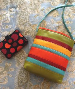 polka dot wallet with black background from Visconti and striped multicolor crossbody, neversaydiebeauty.com