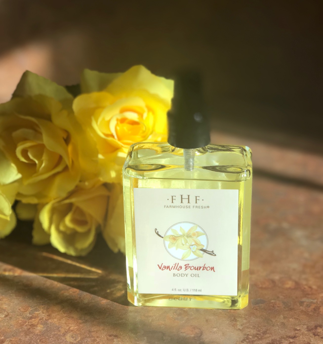clear glass pump bottle of golden Farmhouse Fresh Vanilla Bourbon Body Oil, neversaydiebeauty.com