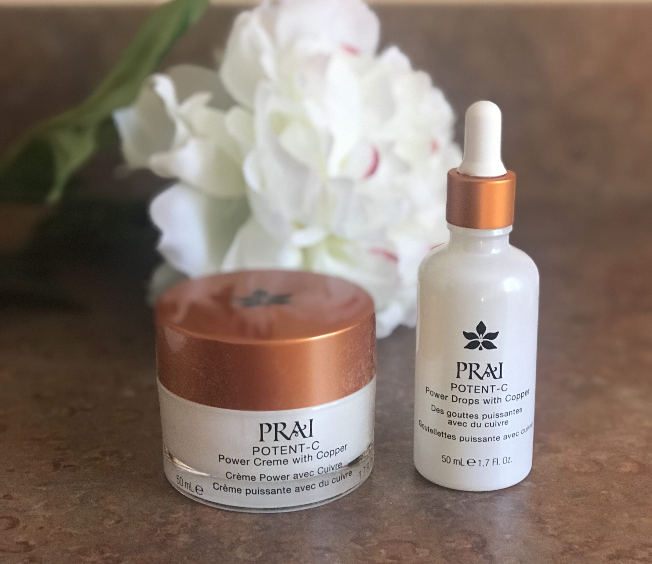 jar and bottle of PRAI Potent-C Power Cream with Copper and Power Drops serum, neversaydiebeauty.com
