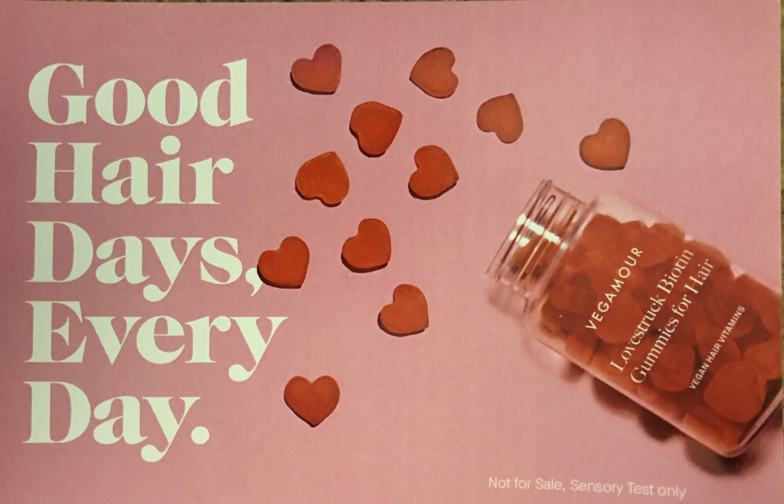 a postcard showing the bottle and heart-shaped biotin gummies from Vegamour