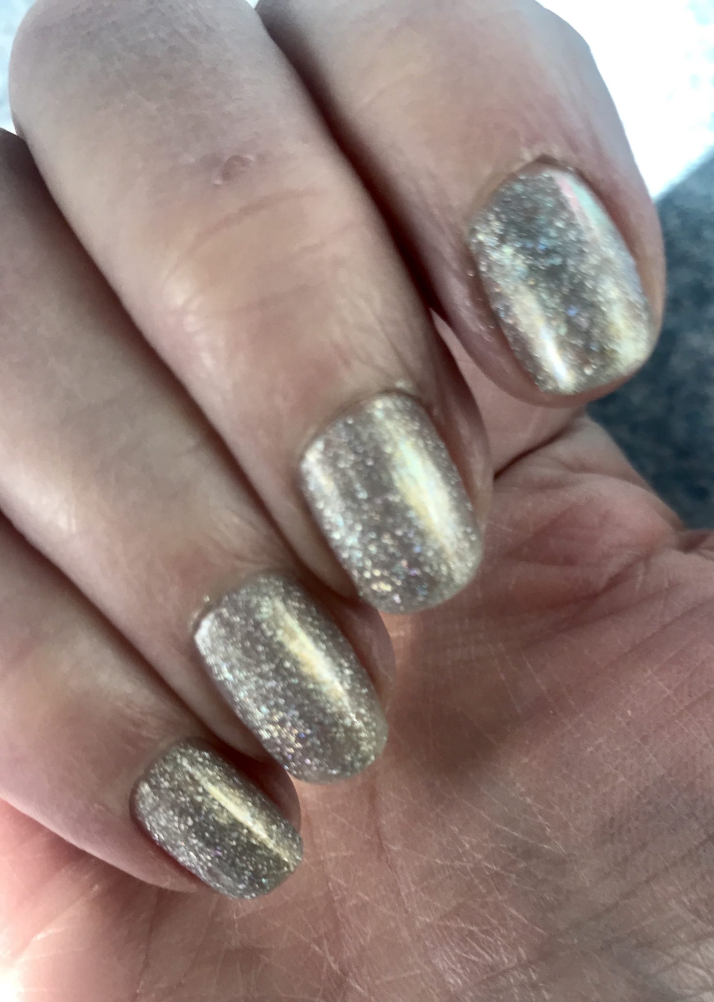 my nails wearing silver holo with a touch of gold, sparkly Alicia from Zoya